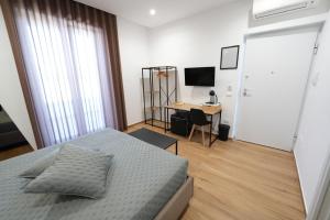 a bedroom with a bed and a desk with a computer at Maison d'Elite in Marigliano