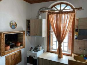 a kitchen with a window and a sink and a stove at Melinda Tower in Plomari