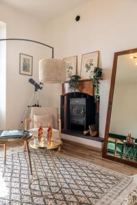 a living room with a fireplace and a mirror at Panoramic Stone Retreat - Menaggio by LoveComo in Menaggio