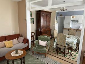 a living room with a couch and a table at Maison Quebec in Bernières-sur-Mer