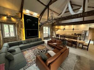 a large living room with couches and a kitchen at Château des Salettes in Anoye