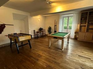 a living room with a ping pong table and a table at Château des Salettes in Anoye