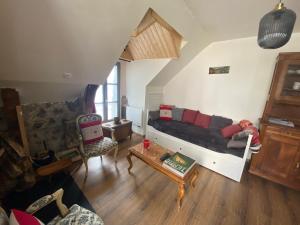 a living room with a bed and a table at Coco Bonnevie in Murat