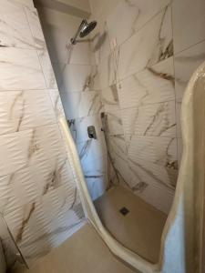 a bathroom with a shower with a toilet at Afrodite Hotel in Tinos +158 photos