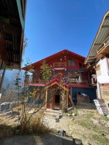 a large red building with a red roof at Infinity Snowline , Kalga in Kalgha +26 photos