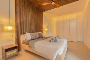 a bedroom with a bed with a ceiling fan at Villa Marni in Xlendi +81 photos