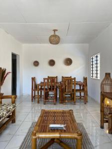 a living room with a table and chairs at Villa Mondoukou Beach in Île Bouët
