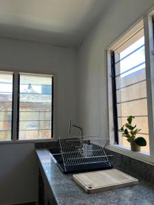 a kitchen counter with a sink and two windows at Villa Mondoukou Beach in Île Bouët +19 photos
