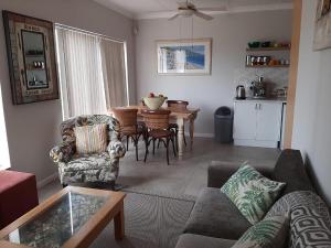 a living room with a couch and chairs and a table at Hartmel Sea Deck in Hartenbos