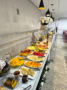 a buffet line with many plates of food at Hiber Hotel - Acesso a Chapecó in Chapecó