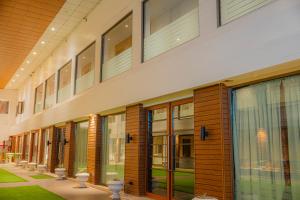 a large building with glass doors and windows at Hotel Prince Residency, Bhuj in Bhuj
