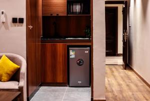a living room with a refrigerator in a room at شقق ثري ستار للشقق المخدومة 1 in Riyadh