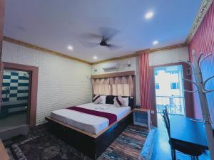a bedroom with a large bed and a window at Hotel Aanandalok in Pānigata +10 photos