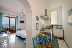 a kitchen and living room with a bed and a table at Il Giardino Dei Limoni in Praiano +62 photos