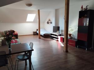 a living room with a table and a couch at Krčma na statku in Zásmuky