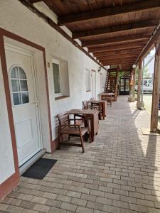 a row of wooden benches sitting on a patio at Pension Assenheim in Assenheim
