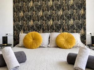 a bedroom with two yellow pillows on a bed at Casa Etxetxoa - Calpe in Ifach +12 photos