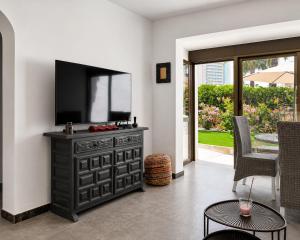 a black dresser with a flat screen tv on a wall at Casa Etxetxoa - Calpe in Ifach