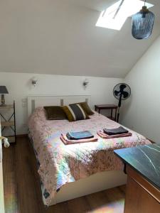 a bedroom with a bed with blankets and pillows on it at Coco Bonnevie in Murat