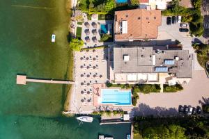 an aerial view of a house next to the water at Hotel Tre Vele in Sirmione