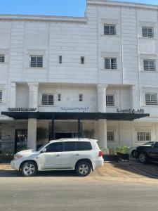 a white suv parked in front of a building at شقق ثري ستار للشقق المخدومة 1 in Riyadh