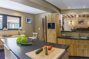 a kitchen with a counter with vegetables on it at Lodge de Loire - B & B proche Chambord in Saint Laurent Nouan