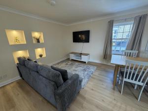 a living room with a couch and a table at Ely Stays City Center 2 Bedroom Flat in Ely