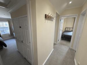 a hallway with a bedroom and a bed in a room at Ely Stays City Center 2 Bedroom Flat in Ely
