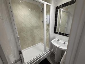a bathroom with a shower and a sink at Ely Stays City Center 2 Bedroom Flat in Ely +1 photo