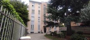 an apartment building with a tree in front of it at Margot's House Rho in Rho