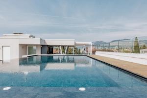 a swimming pool on the roof of a house at Solho Hotel in Bardolino