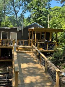 a house with a wooden walkway leading to it at Canvasback Cove on Caddo Lake in Jefferson