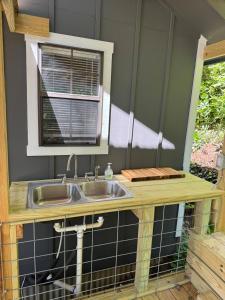 a kitchen with a sink and a window at Canvasback Cove on Caddo Lake in Jefferson