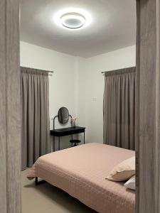 a bedroom with a bed and a table with a mirror at Nenes Comfort Apartment in Koroni