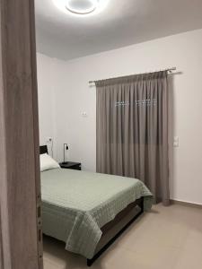 a bedroom with a bed and a window at Nenes Comfort Apartment in Koroni