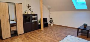 a living room with a wooden floor and a mirror at Krčma na statku in Zásmuky +11 photos