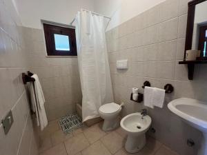 a bathroom with a toilet and a sink at Agriturismo Monte Sacro in Mattinata +87 photos