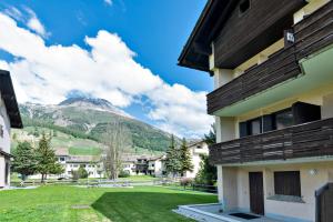 a building with a view of a mountain at Chesa Silvretta - Celerina in Celerina