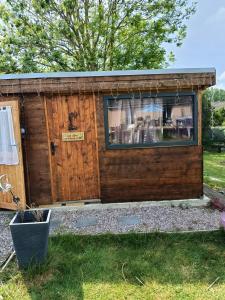 a log cabin with a window and a door at La chambre secrète des sorciers in Longueval