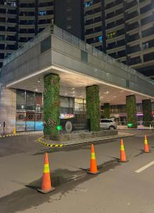 a parking lot with orange cones in front of a building at Knightsbridge Residences in Manila