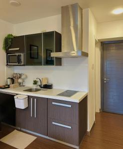 a kitchen with a sink and a counter top at Knightsbridge Residences in Manila