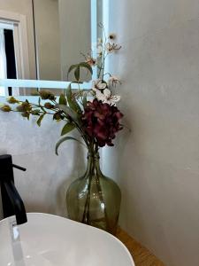 a vase filled with flowers sitting on a table at LUSAIL 1ª línea playa ADULTS ONLY in Vinarós +21 photos