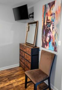 a room with a chair and a mirror and a dresser at Tiny Palace - 1-Bedroom Apartment - Multi-Week Stay - Pool - Washer-Dryer - Dog-friendly with fee for 1 Family Pet in Wilmington