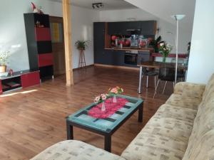 a living room with a couch and a table at Krčma na statku in Zásmuky
