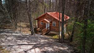 a small log cabin in the woods at Cardinal's Crest in Logan