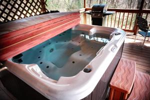 a hot tub with a wooden roof on a deck at Cardinal's Crest in Logan
