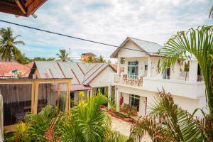 a group of houses with trees and plants at Karibu House Paje in Paje