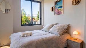 a bedroom with a large bed with a window at Lis Oureto in Saint-Cyr-sur-Mer +5 photos
