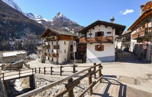 a group of buildings with mountains in the background at Amazing Apartment In Cogne in Cogne +13 photos