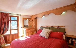 a bedroom with a bed with red sheets and a window at Amazing Apartment In Cogne in Cogne